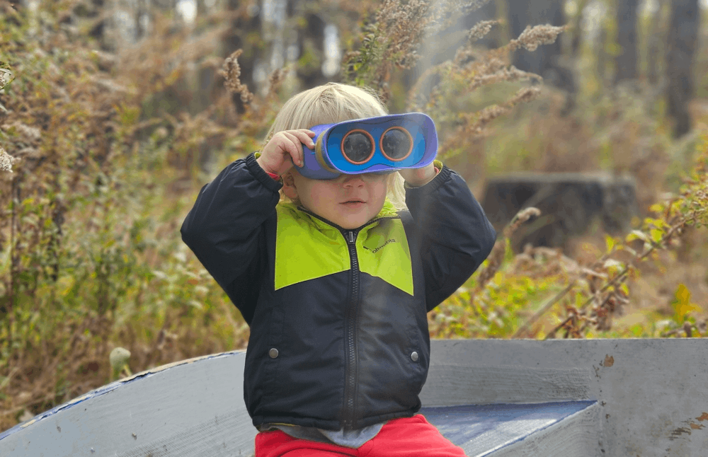 boy looking through binoculars