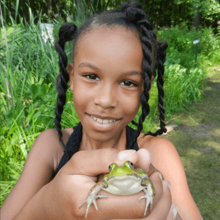 young girl holding a frog