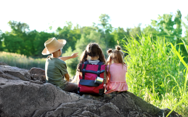 kids gathered around a table with produce